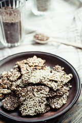 crackers from flax seed, sesame, sunflower and spices on a dark