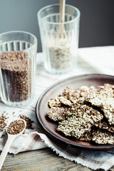 crackers from flax seed, sesame, sunflower and spices on a dark