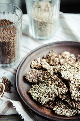 crackers from flax seed, sesame, sunflower and spices on a dark
