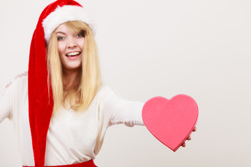 Happy cute woman with heart shape box. Christmas.