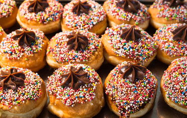 Fresh donuts on the display at bakery for Hanukkah celebration.