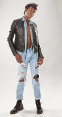 Attractive Young Man in Ripped Jeans and Leather Jacket