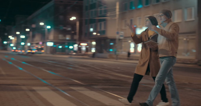 Young couple using pad to find the way in big city