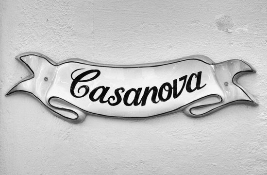 Street sign in Mdina,Malta, with the text “Casanova” (black and white tones).
