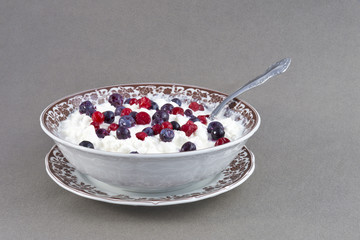 Wild berries with curd and sour cream.
