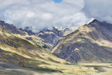 Remote river valley among majestic high mountains