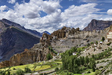 Tibetan style white buildings on high rock scars Dhankar monastery panorama