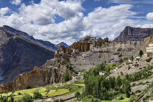Tibetan style white buildings on high rock scars Dhankar monastery panorama