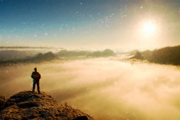 Watercolor paint. Paint effect. Man stands on the peak of sandstone rock in national park Saxony Switzerland and watching to Sun. Beautiful moment.