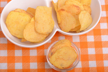 chips and peeled potato on a white plate