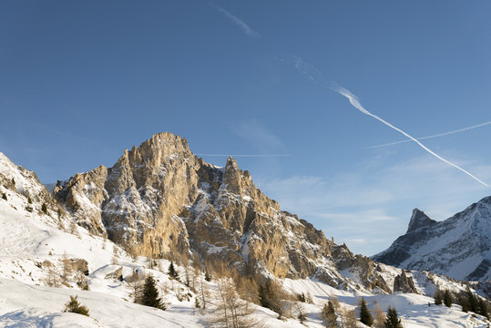 Rocky ridge among winter alpine landscape at evening