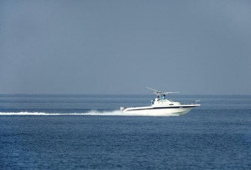 Fototapeta na wymiar Early morning fisher men moving in sea on speedboat
