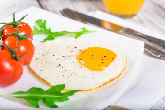 Breakfast with egg on wooden table