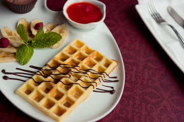 Belgian wafers with hot chocolate and strawberry sauce