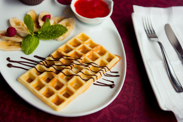 Belgian wafers with hot chocolate and strawberry sauce