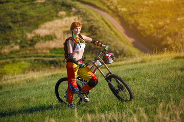 Fototapeta premium Extreme sports - young woman with downhill bike