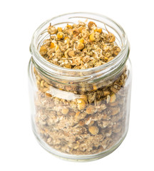 Dried chamomile herbal tea in mason jar over white background