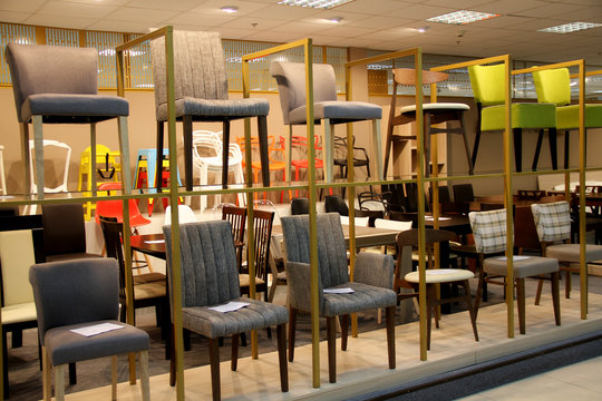 Colored stools and chairs in furniture store 