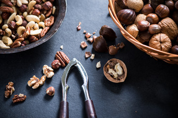 mixed nuts in basket and nut cracker from above