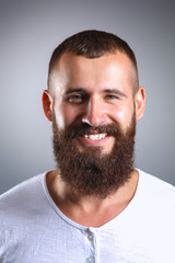 Obraz premium Portrait of handsome man standing, isolated on grey background