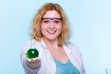 female chemistry student with glassware test flask.