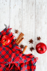 
Christmas winter background, red apples with cinnamon, spices , Christmas cookies and cocoa on a...