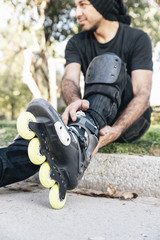 Urban young man roller sitting on the floor