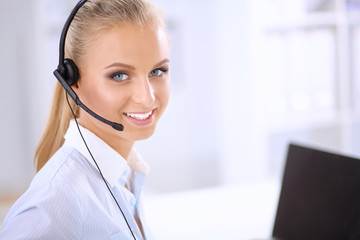 Close-up portrait of a customer service agent sitting at office