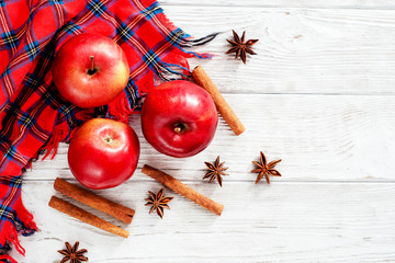 
Christmas winter background, red apples with cinnamon, spices , Christmas cookies and cocoa on a white wooden background
