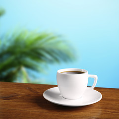 Cup of coffee on table on nature background
