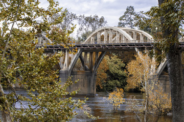 Bridge over a river with fall foliage