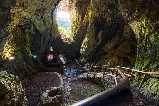 Cave Interior with Stone Staircase of Predjama Castle in Slovenia. Famous European Tourist Place.