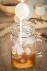 Milk pouring for fresh iced coffee