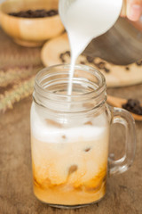 Milk pouring for fresh iced coffee