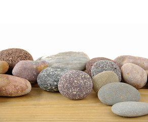 Fototapeta na wymiar Pile of stones on wood texture