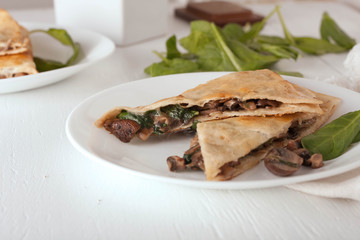 mushroom spinach quesadilla on white plate