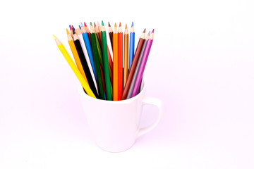 Color pencils in white mug on white background
