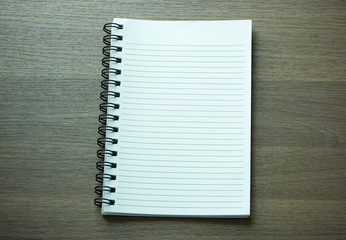 blank spiral notebook on dark wood background