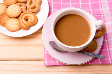 cup of coffee and cookies on wooden