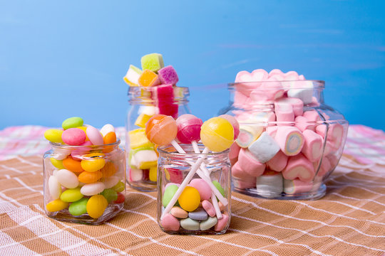 Colorful candy in jar on table