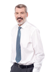 Smiling businessman with hands in pocket