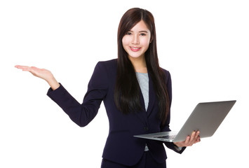 Young Businesswoman hold with laptop computer and open hand palm