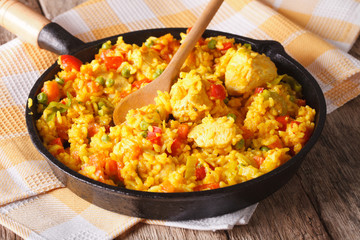 Arroz con pollo - rice with chicken in a frying pan closeup. horizontal

