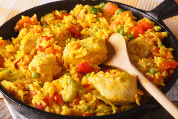Arroz con pollo - rice with chicken in a bowl pan. Horizontal
