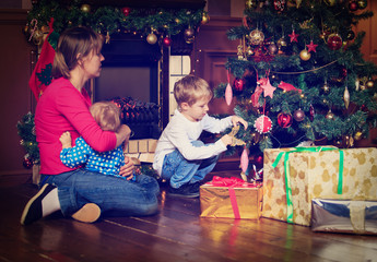 mother and kids decorating home at christmas