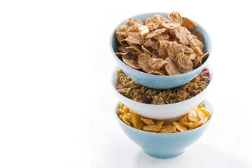 assortment of breakfast cereal in bowls, isolated
