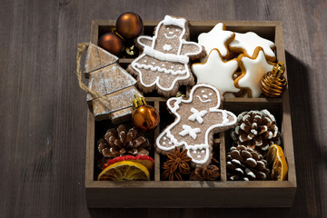 Christmas symbols in a wooden box on dark wooden background