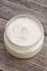 Obraz na płótnie Canvas sweet milk cream in a glass jar, top view