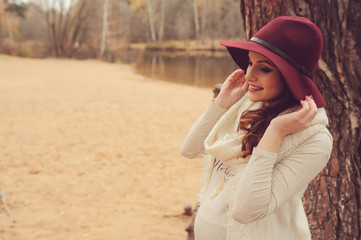 pregnant woman walking outdoor, cozy mood, soft toned