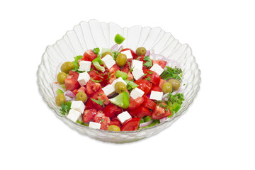 Greek salad in a glass salad bowl